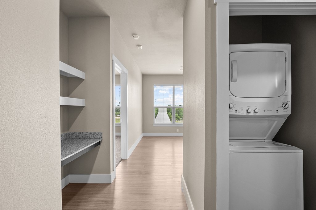 an empty laundry room with a washer and dryer in it