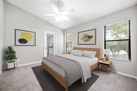 a bedroom with a bed and two windows