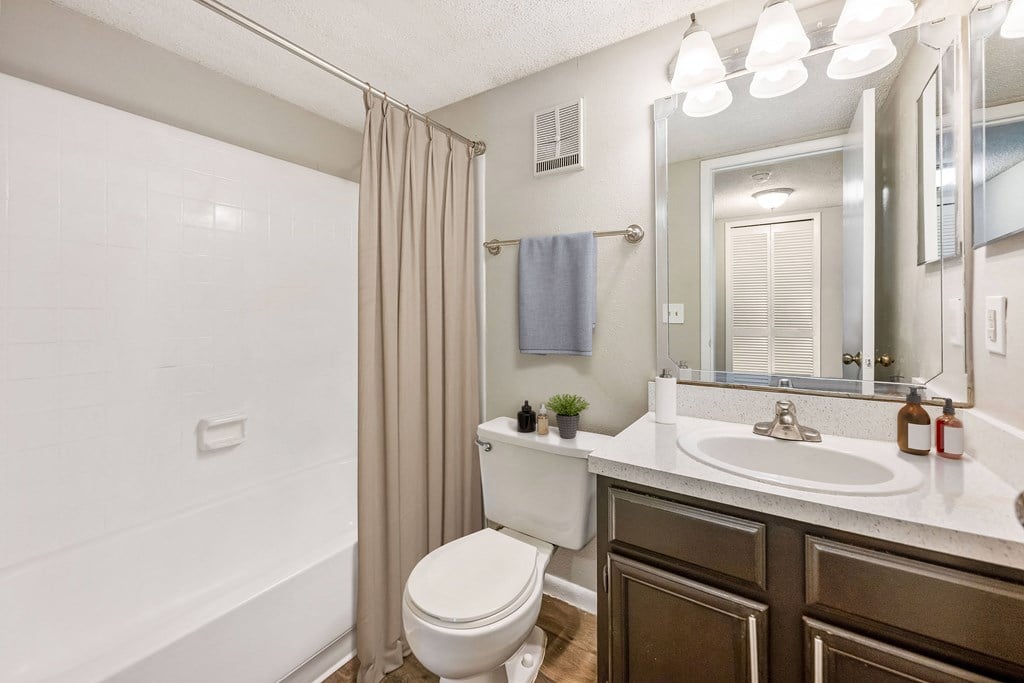 a bathroom with a toilet sink and shower