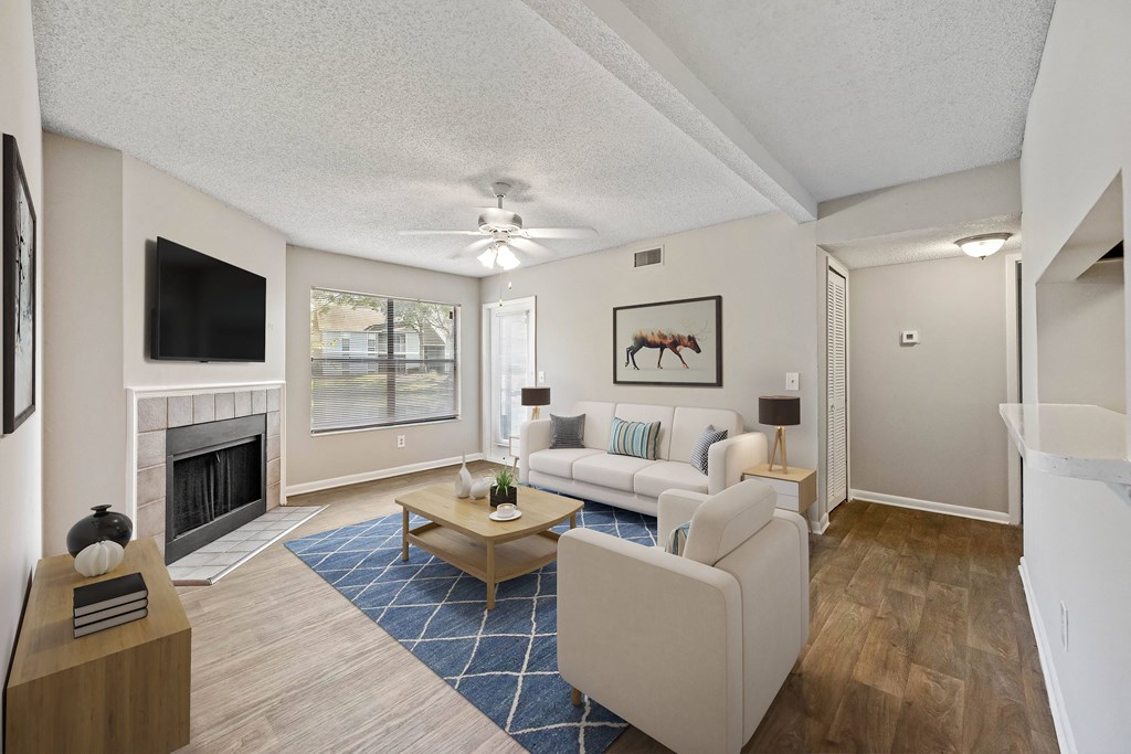 a living room with a fireplace and a large window