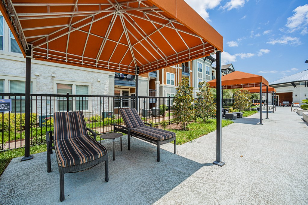 lounge area with umbrellas and lounge chairs