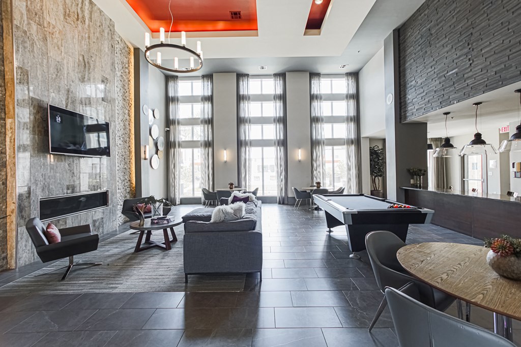an open living room with a pool table and a flat screen tv