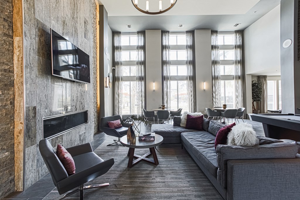 a living room filled with furniture and a large window