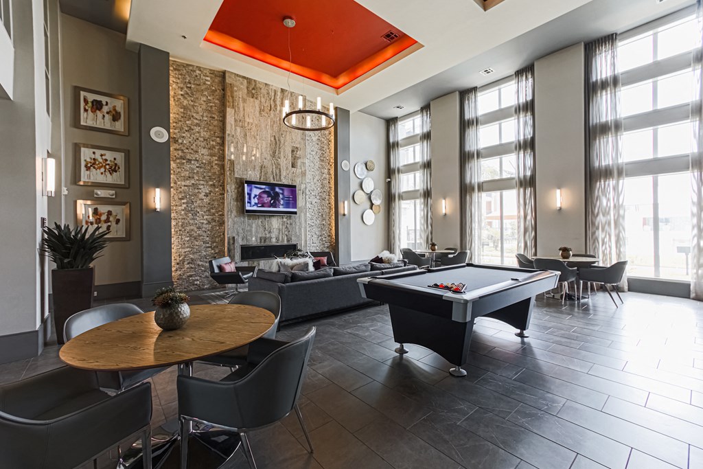 a large living room with a pool table and a flat screen tv