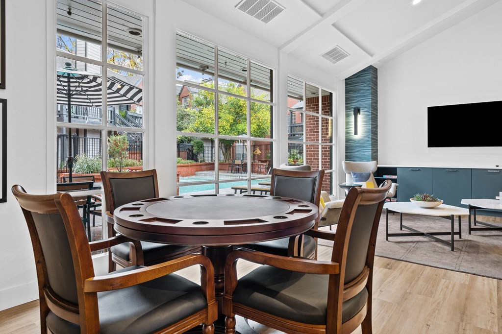 a dining room with a table and chairs and a large window
