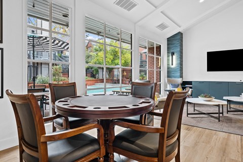 a dining room with a table and chairs and a large window