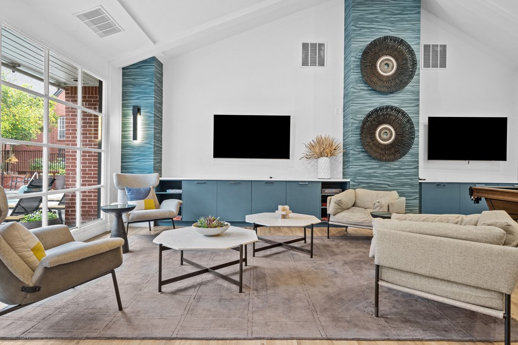 a living room with couches and chairs and a television