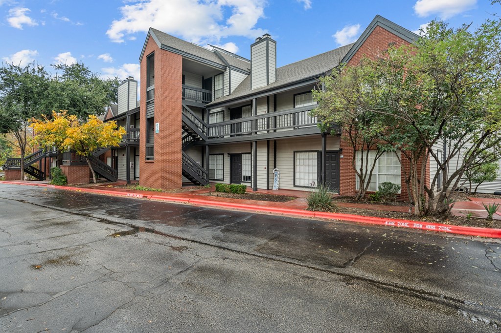 an empty street in front of an apartment building