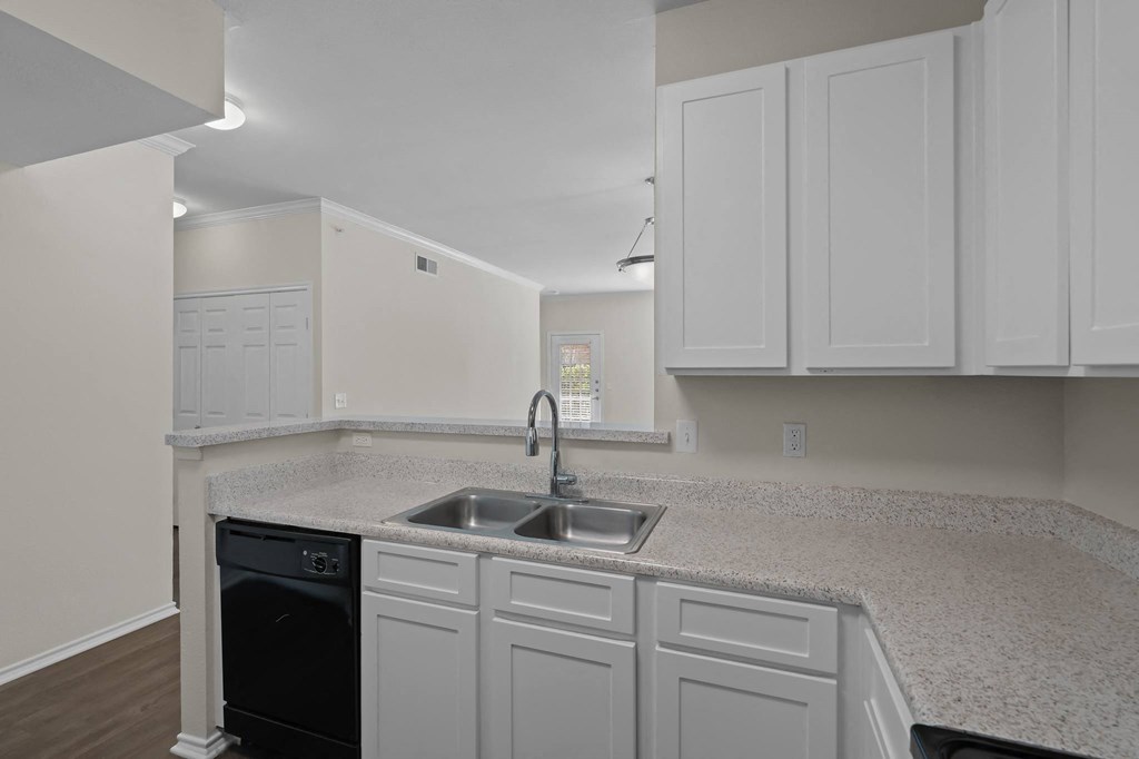 a kitchen with white cabinets and a sink