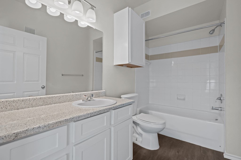 a bathroom with a sink toilet and a bath tub