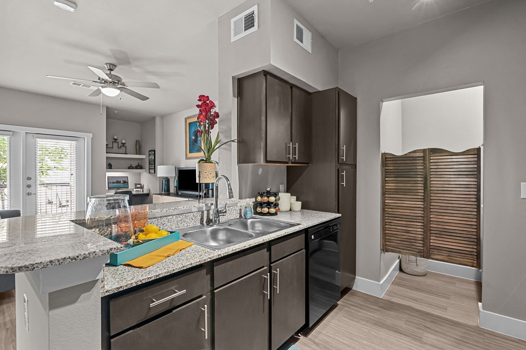 an open kitchen with stainless steel appliances and granite counter tops