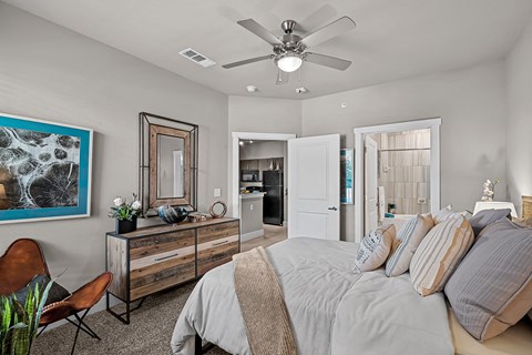 a bedroom with a large bed and a ceiling fan