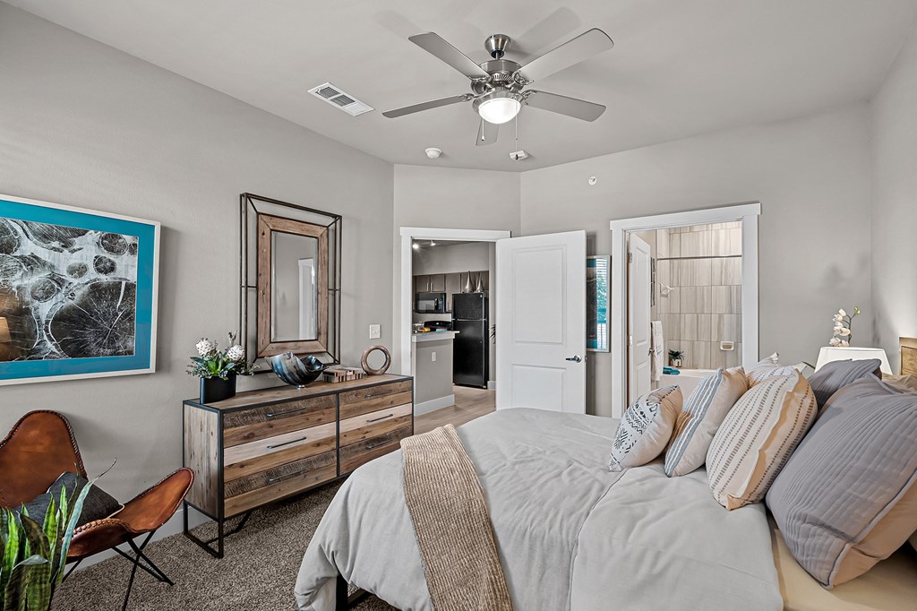 a bedroom with a large bed and a ceiling fan