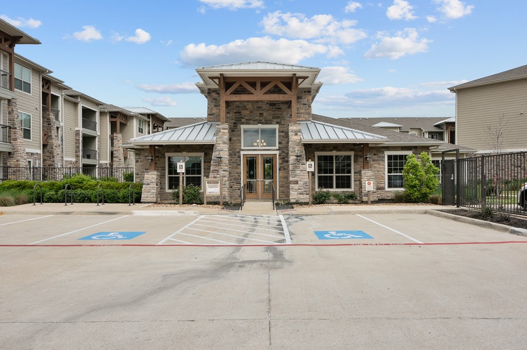 an empty parking lot in front of an apartment building