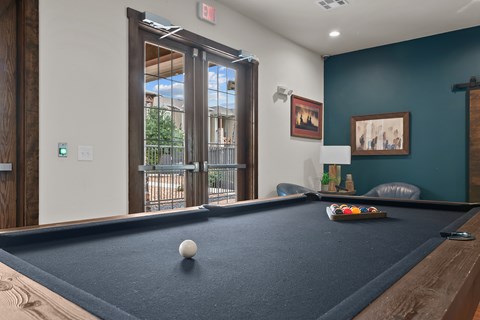 A pool table with a white ball on it.