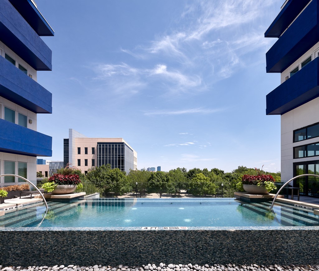a swimming pool in the middle of two apartment buildings