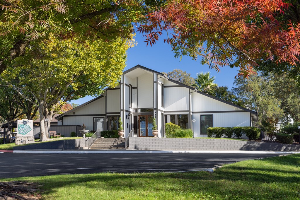 A modern house with a white exterior and a large front porch.