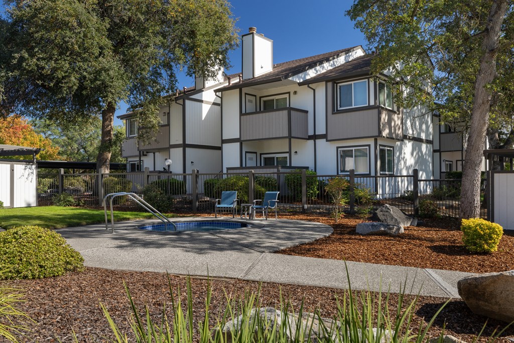 A large white house with a pool in the backyard.