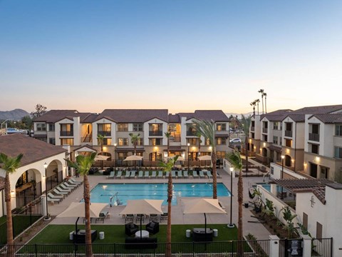 A resort with a pool and palm trees.