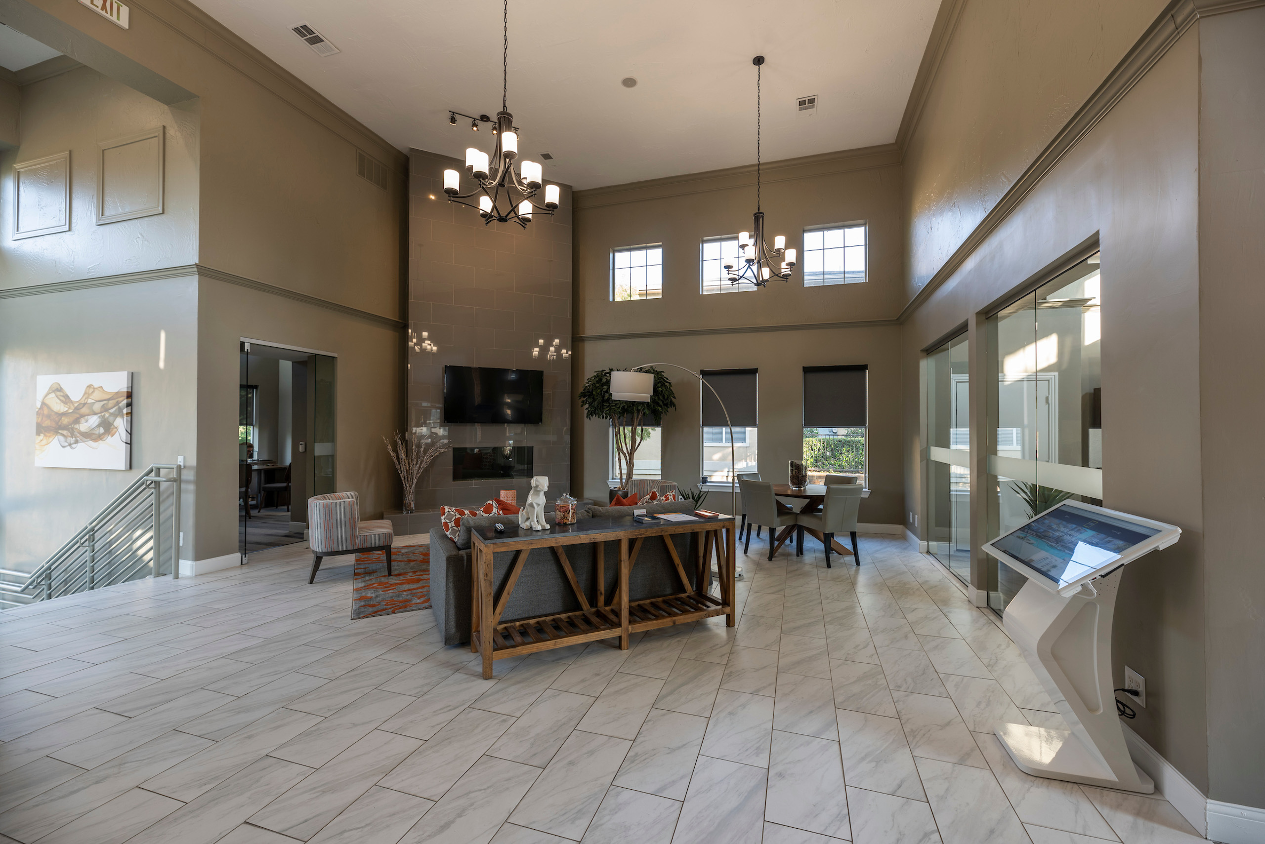 A large, modern living room with a wooden table and chairs.