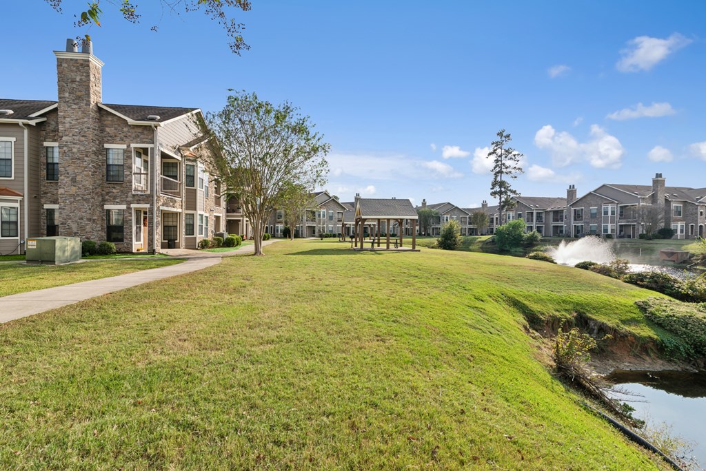 A row of houses with a grassy area in front.