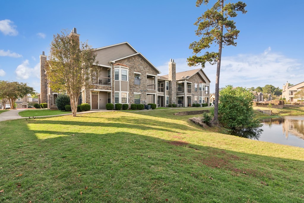 A large house with a green lawn in front.