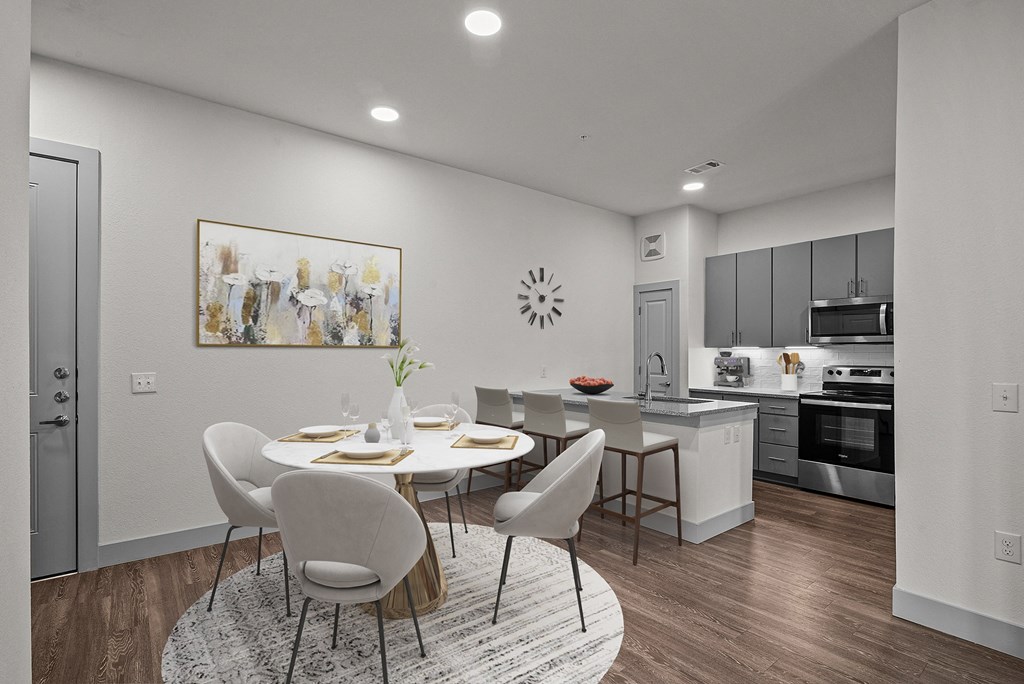an open kitchen and dining room with a table and chairs