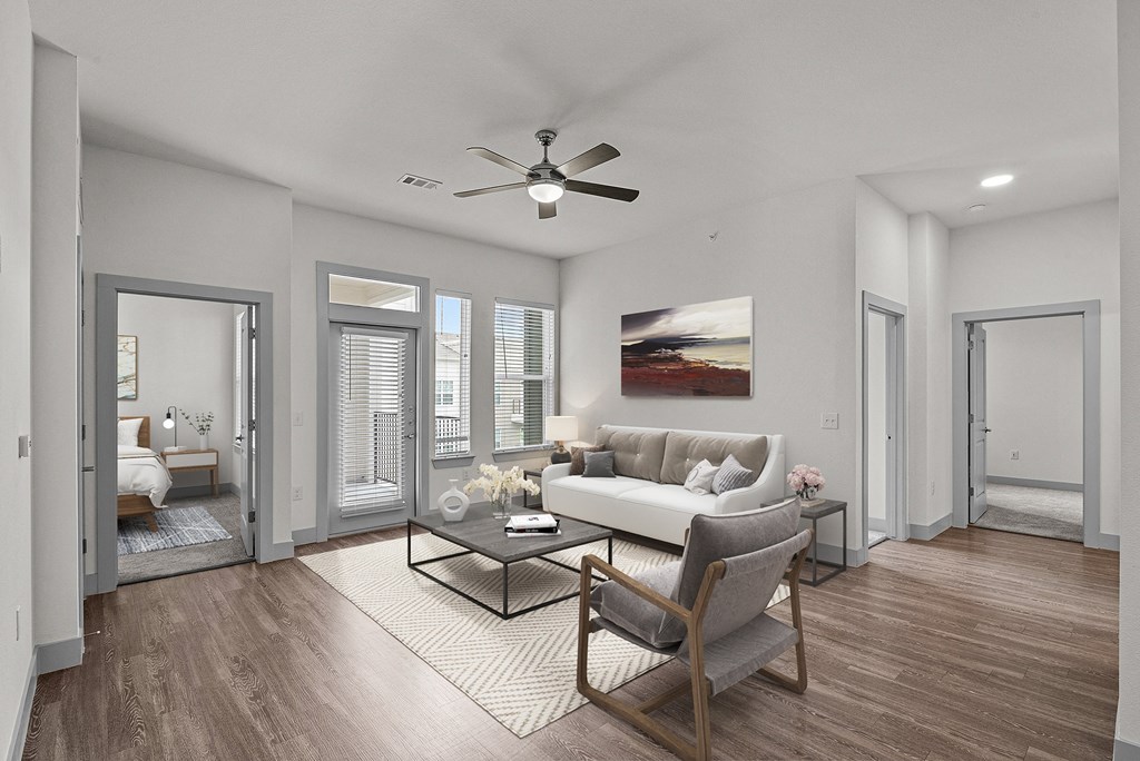 a living room with a couch and a ceiling fan