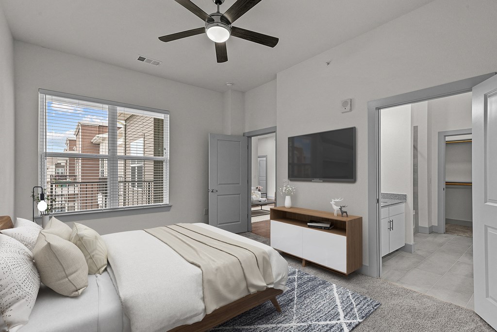 a bedroom with a large bed and a ceiling fan