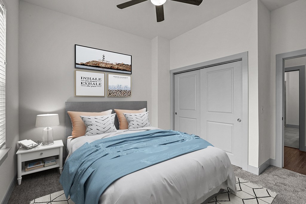 a bedroom with a bed and a ceiling fan