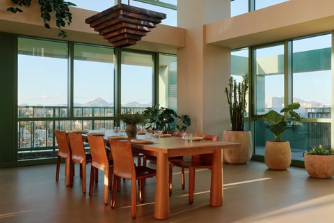 A dining room with a long table and chairs.