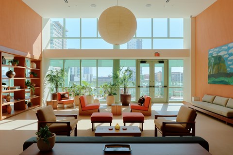 A living room with a large table and chairs.