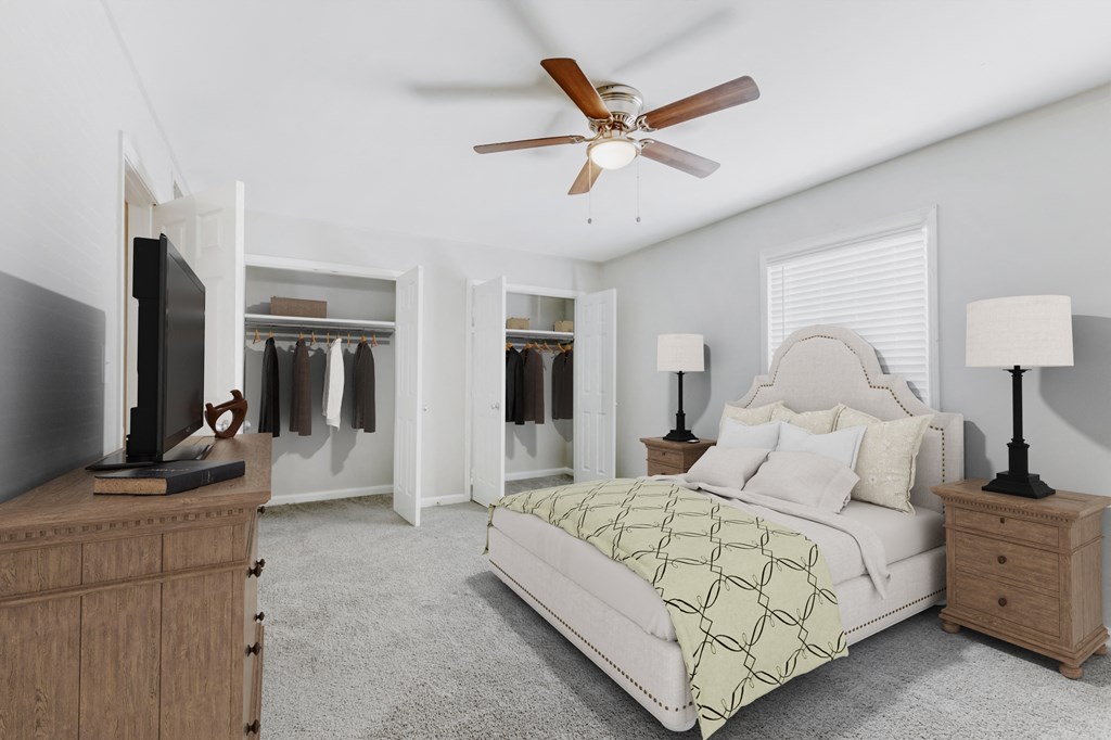 a bedroom with a bed and a ceiling fan