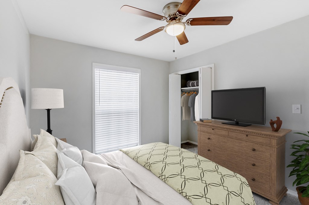 a bedroom with a large bed and a ceiling fan