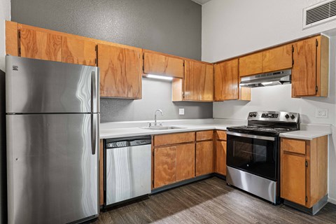 A kitchen with wooden cabinets and stainless steel appliances.