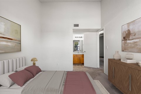 A bedroom with a large bed and a painting on the wall.