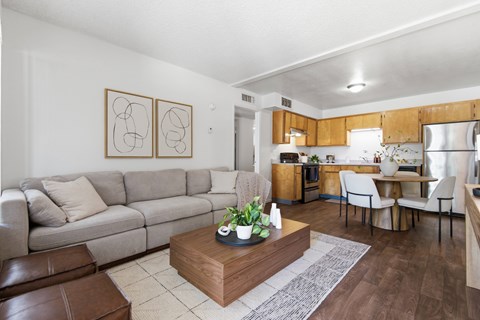 A living room with a grey couch and a coffee table in the middle.
