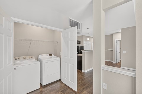 A white washer and dryer in a laundry room.