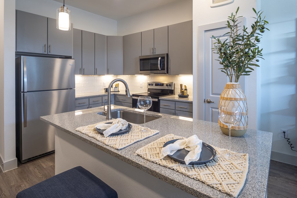 a kitchen with stainless steel appliances and granite counter tops