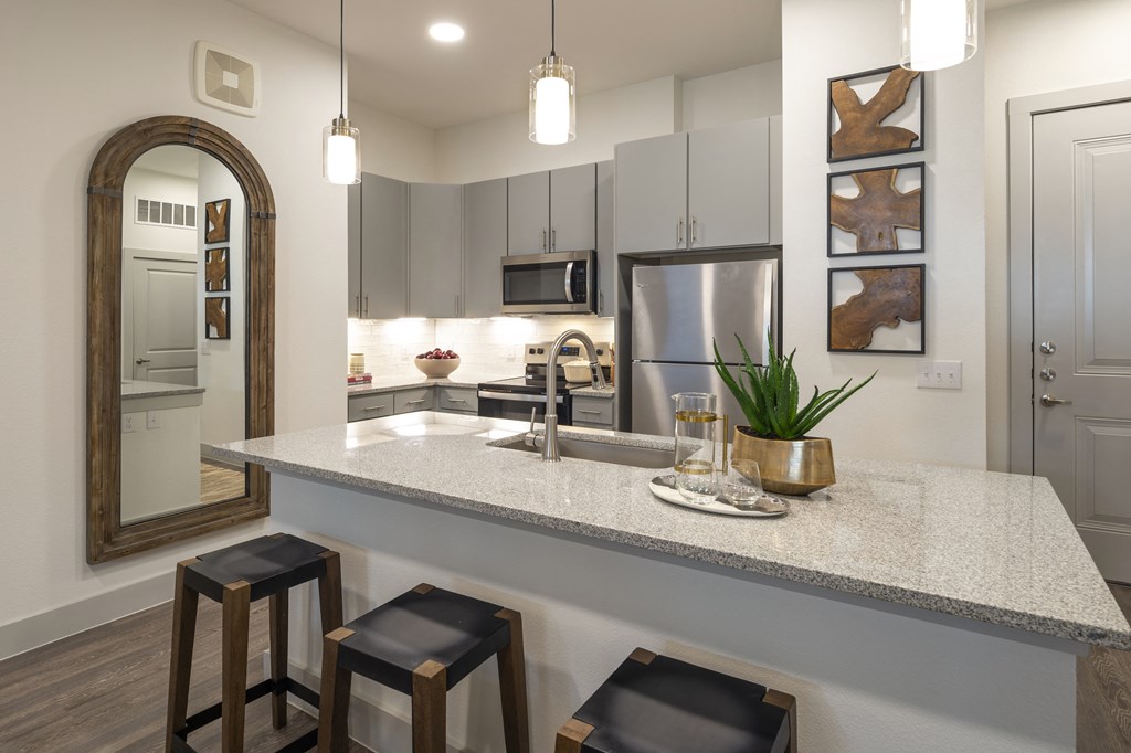 a kitchen with a granite counter top and stools