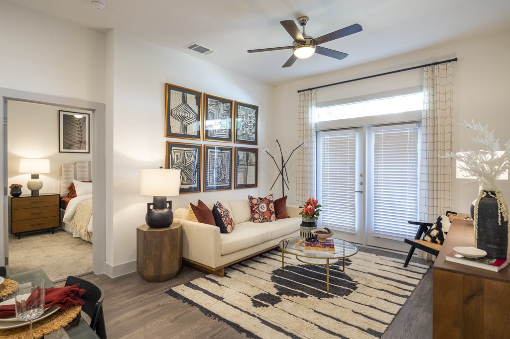 a living room with a couch and a ceiling fan