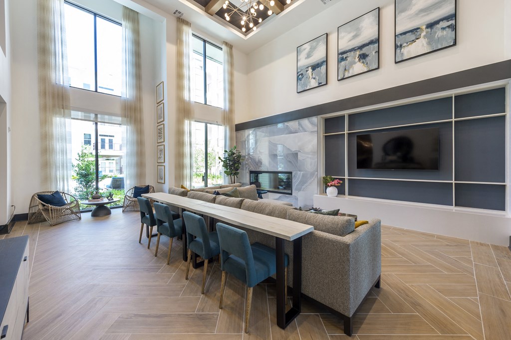 a large living room with a long table and chairs