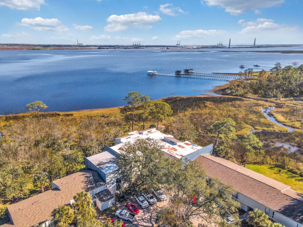 an aerial view of a house near a body of water
