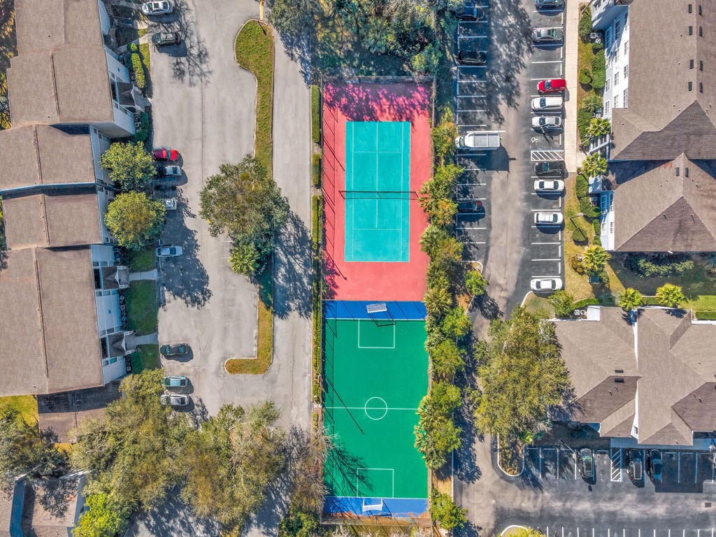 an aerial view of a tennis court on a city street