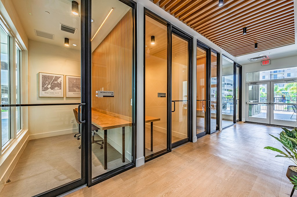 A room with a wooden ceiling and a glass door.