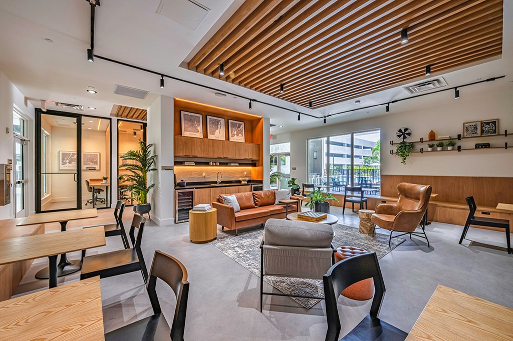 A modern living room with wooden furniture and a high ceiling.