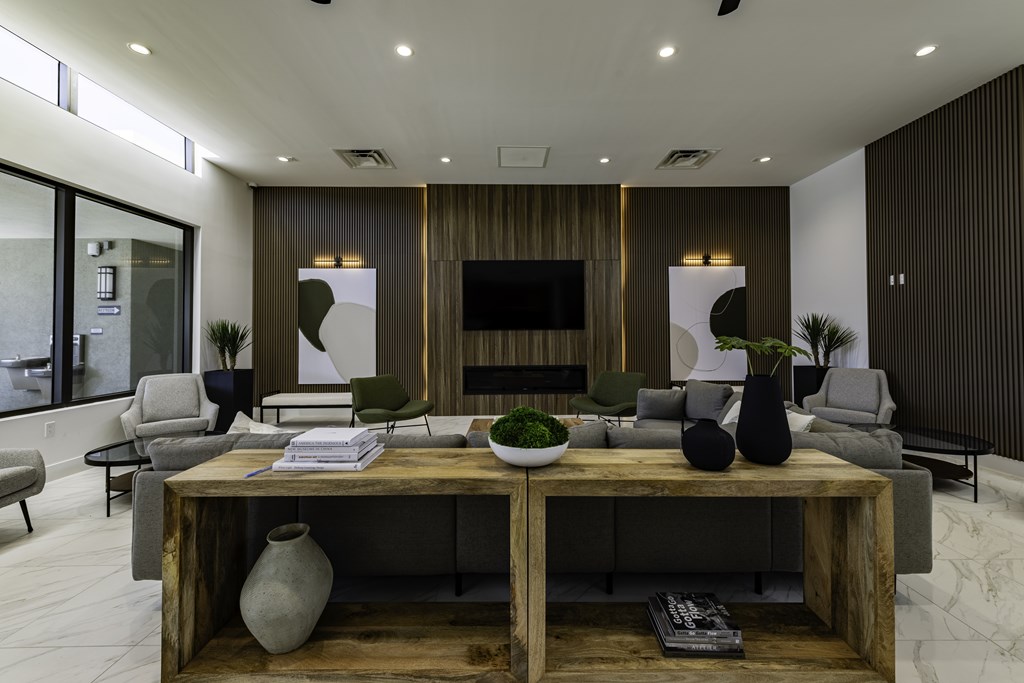 A modern living room with a wooden coffee table and grey couches.