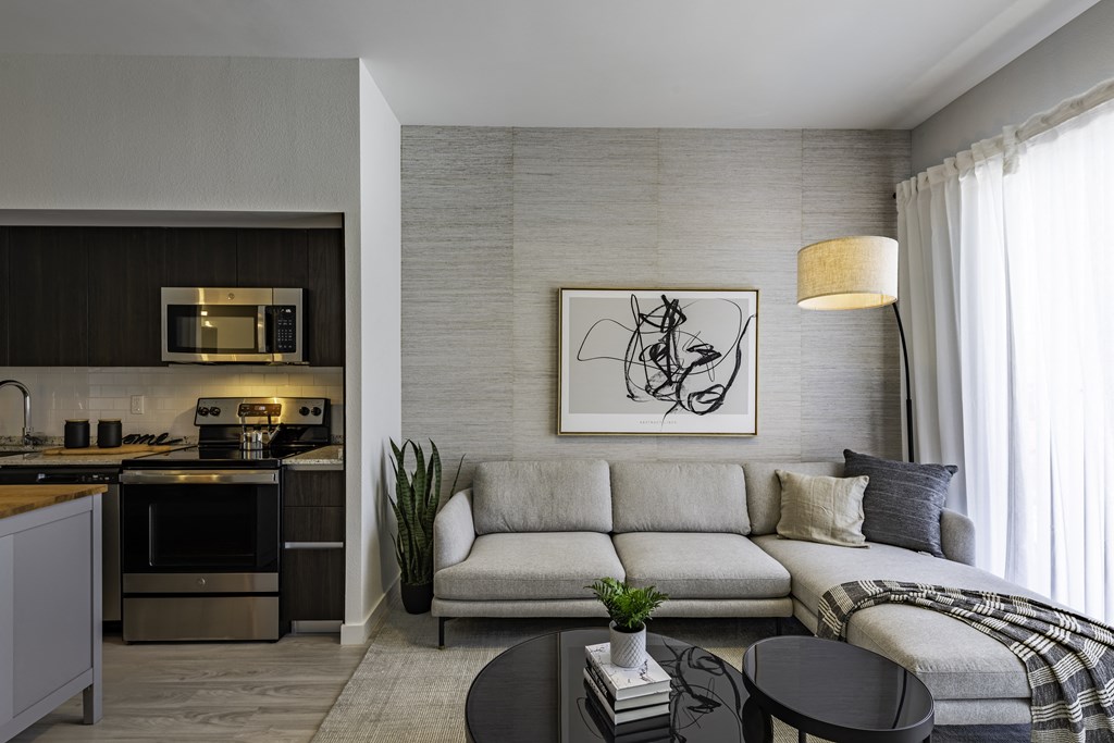 a living room with a couch and a table the gym  at a residential apartment community Resia in Decatur GA