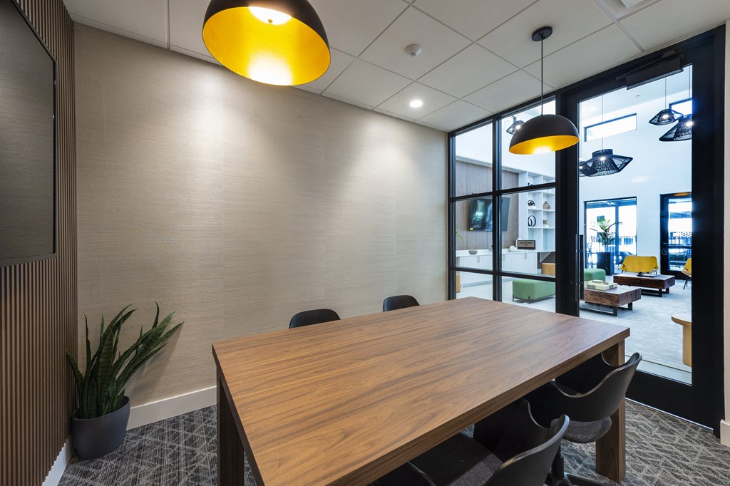 a conference room with a wooden table and chairs