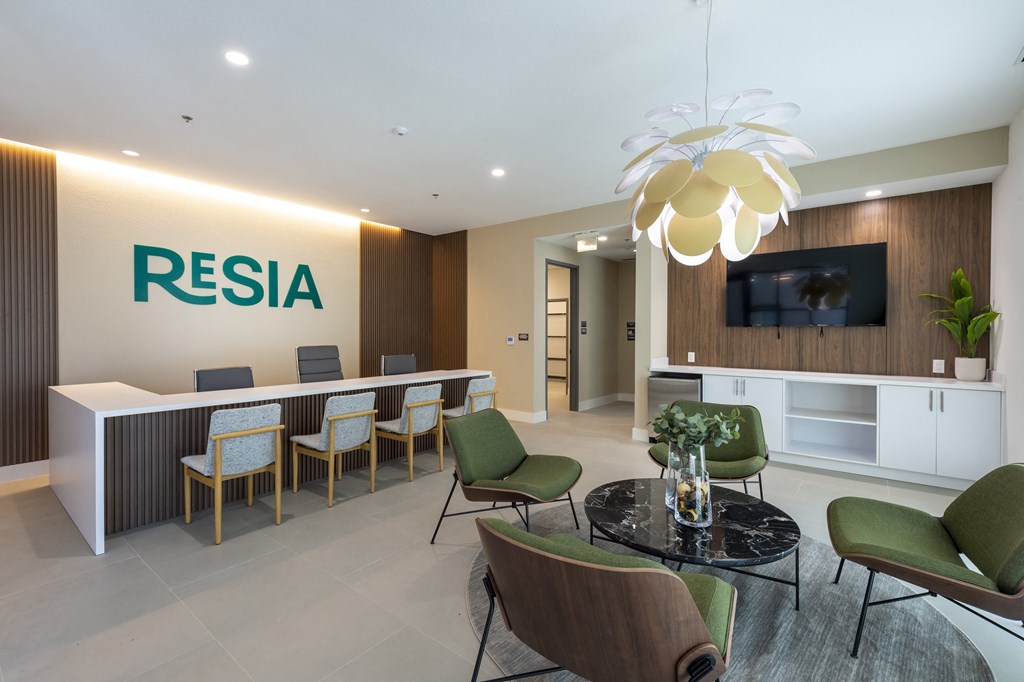 a lobby with a reception desk and a table with chairs